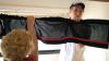 Michael Cooper, with the help of his grandmother Diana, sets up a curtain in his dorm room in the Watters Complex. - Photo by Kyle Kurlick