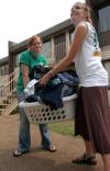 Kinsey Bolinger, junior Biblical studies major, and Emily Watlington, junior social work major, carry in some clothes to help a freshman move in.    - Photo by Heather Phillips