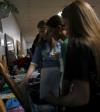 Senior Cara Yates, intercultural studies major, shows Senior Melissa Jep, biology major, and Freshman Carrie Smith, nursing major, the ZTA display in the Campus Life Fair during New Student Orientation. - Photo by Heather Phillips