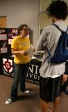 Sophomore Kelly Northam, business major, talkes to freshman Ryan Brewer, digital media studies major, about the Student Government Association at the Campus Life Fair during New Student Orientation. - Photo by Heather Phillips