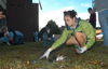 The Union community banded together to clean-up the tornado damage on Monday morning.  Pictured here is Sarah Thompson, a junior music major from Arkadelphia, AR, picking up shards of glass knocked out of dorm windows by the tornado. - Photo by Jim Veneman