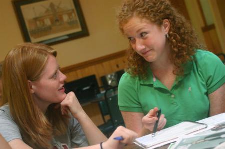 Sarah McBroom and Heidi Steinrock, news editors, discuss new ideas for the newspaper at the Cardinal & Cream retreat.