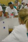 Alessandro Oliveira, from Brazil, plays a game with bottle caps with Abigail Williams, from Crossvile, Tenn., at the ice cream social during New Student Orientation.  - Photo by Stephanie Schroeder