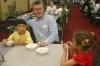 Director of Enrollment Services Robbie Graves sits with his children as they enjoy the ice cream served in Coburn during New Student Orientation. - Photo by Stephanie Schroeder
