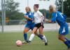 Roxanna Skelton, freshman defender (white jersey), dribbles the ball away from Brescia (Ky.) players. - Photo by Steven Aldridge