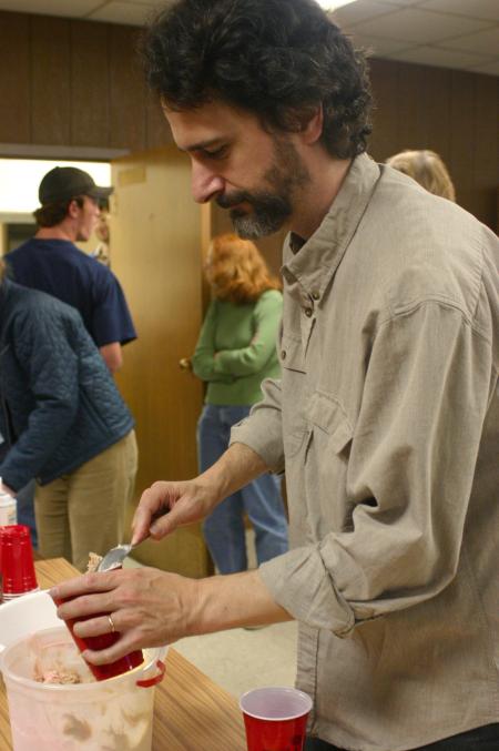 Tim Lowly, a guest artist from Chicago, serves himself ice cream for dessert during the art retreat.