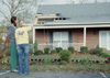 Senior Nicole Geyer, biology major, and junior Ashley Larue, public relations major, examine the damage done to the Kappa Delta house after the tornado. - Photo by Lindsay Stavish