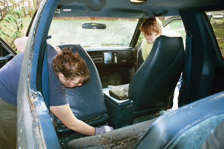 Massive winds and flying debris caused many students like sophomore Zandrea Jackson, art major, and senior Gin Langford, psychology major, to clean glass out of their cars.