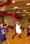 Sophomore guard Tony Brown (white jersey) takes a shot in the Homecoming game versus Olivet Nazarene University (Ill.). - Photo by Morris Abernathy