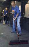 Freshman Whitney Jones, biology major, and Freshman Ashley Bruski, education major, sweep up during their Day of Remembrance project at Youth Town.   - Photo by Heather Phillips