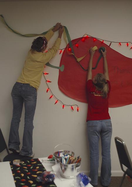 Freshmen Bethany Anderson and Chanel Watson decorate Evangelical Community Church in Jackson on the Day of Remembrance.