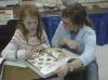 Junior Mary Ellen Vaughn, learning foundations major, reads to a child at Jackson Christian School on the Day of Remembrance. - Photo by Holly Gushee
