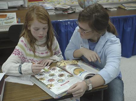 Junior Mary Ellen Vaughn, learning foundations major, reads to a child at Jackson Christian School on the Day of Remembrance.