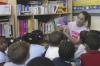 Freshman Saran Greenlee reads a story to pre-K students at Alexander Magnet Elementary School during Day of Remembrance. - Photo by Stephanie Schroeder