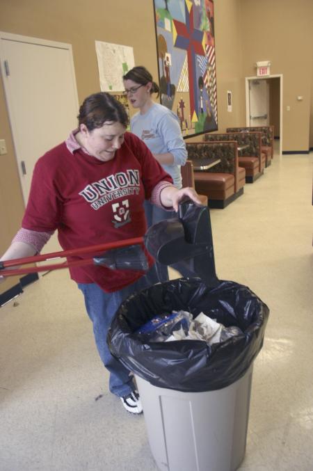 Sophomore Megan March empties the dust pan after sweeping the floors at The Salvation Army during Day of Remembrance.