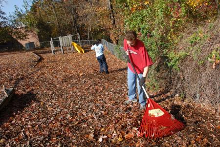 Matt Sengstock and Jasmine Huang do some yard clean up at the YMCA during Day of Remembrance.
