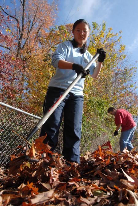 Jasmine Huang cleans up the playground at the Jackson YMCA during Day of Remembrance.