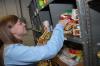 Alpha Psi Omega's Jill Casey helps organize food at RIFA on Day of Remembrance. - Photo by Morris Abernathy