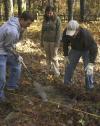 Senior Ben Burleson, history major, Junior Mary Beth Johnson, English major, and Senior John Crawford, history major, search the ground for buried grave stones at the Ames Plantation during a Day of Remembrance project. - Photo by Matthew Diggs