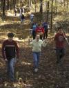 Cameron Armstrong, Racheal Pressnell, Josh Abbotoy and the rest of the history department group walk out of the woods after searching for buried grave stones at the Ames Plantation during a Day of Remembrance project. - Photo by Matthew Diggs