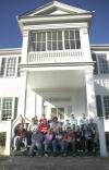 A group of history faculty and students pose for a group shot at the Ames Plantation after a day of grave site searching during a Day of Remembrance project. - Photo by Matthew Diggs