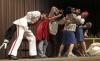The wolf, played by Andy Morris, attempts to blow down the house of bricks in the Union University Players production <em>The Trial of the Big Bad Wolf</em>. - Photo by Kyle Kurlick