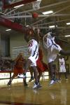 D.J. Sissoko and Josephine Owino jump to grab the ball for a rebound in a game against Georgetown College, Ky. - Photo by Stephanie Schroeder