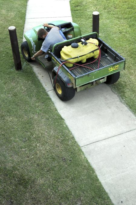 Matt Brasfield uses his Gator and spray rig to keep the weeds at bay on Union's campus around the McAfee residential complex.