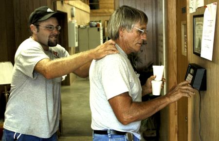 Matt Brasfield congratulates Robert Cox, director of the grounds crew, at the close of a work day capping off eight full hours of work in the hot Tennessee sun.