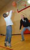 Andrew Courtner plays basketball with one of the children at the SAC Carl Perkins' Christmas Party. - Photo by Morris Abernathy