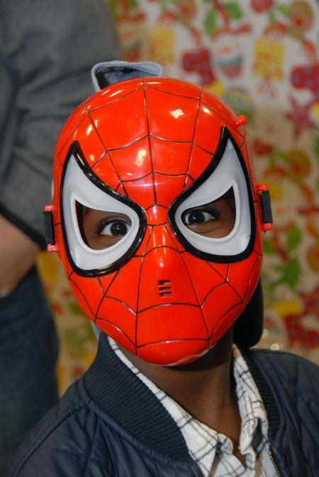 One of the children at the SAC Carl Perkins' Christmas Party shows off his new Spiderman mask.