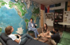 Cindy Jayne, professor of language and director of the Institute for International and Intercultural Studies, chats with students in the International Student Center. - Photo by Jim Veneman