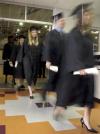 Fall graduates leave the gym at West Jackson to line up for the beginning of their graduation ceremony. - Photo by Kyle Kurlick