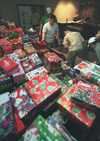 The men of Alpha Tau Omega organize shoeboxes filled with toys and essential items for their Operation Christmas Child drive. - Photo by Justin Veneman