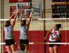 Monica Schirmer, Union senior, hits the ball over the hands of defenders. - Photo by Morris Abernathy