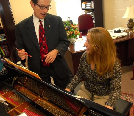 Ron Boud, professor of music, works with Kate Rawls during a keyboarding lesson.