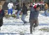 Junior Cody Curtis, music major, gets barraged by snowballs during a snowball fight in the McAfee residence complex. - Photo by Matthew Diggs