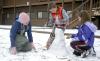 Senior Katie Watson, ESL major, helps Isaac and Anna Elliott, children of McAfee resident director Kelly Elliott, to build a snowman. - Photo by Matthew Diggs