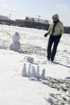 Racheal Pressnell ventured to the intramural field  to imitate the Calvin and Hobbs winter cartoon strip series, one of which includes miniature snowmen as bowling pins and the bigger snowman's head as the bowling ball. - Photo by Stephanie Schroeder