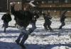 John Henson and other men of McAfee charge each other during a snow ball fight in the McAfee courtyard during a snow day. - Photo by Stephanie Schroeder
