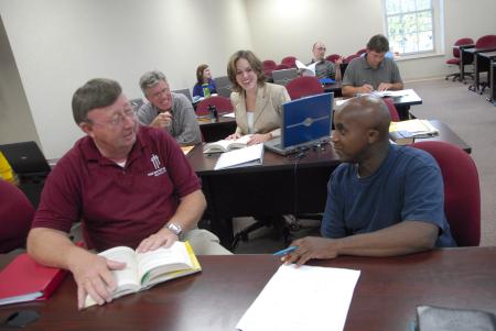 Members of the MCS program fellowship before class.