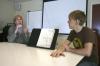 Drew Winter, digital media studies major, listens in his own way to Betty Benson, an interpreter for the deaf, during class. He and other deaf members of the community do not let their disability stop them from living life. Interpreters are available to communicate in public locations. - Photo by Stephanie Schroeder
