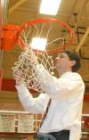 Head Coach Mark Campbell cuts down the nets after the Lady Bulldog's TranSouth Tournament Championship win. - Photo by Morris Abernathy
