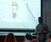 Union alum Kirby Atkins shows clips from <i>Jimmy Neutron</i> during his talk on computer animation and digital filmmaking. - Photo by Cam Tracy