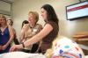 Linda Baker and several Union students check out the new birthing simulator in the nursing department during the White Hall dedication ceremony. This simulator can go into labor between 15 minutes and 15 hours. - Photo by Kyle Kurlick