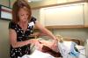 Christie Pawley demonstrates the inside of the birthing simulator at the White Hall dedication. - Photo by Kyle Kurlick