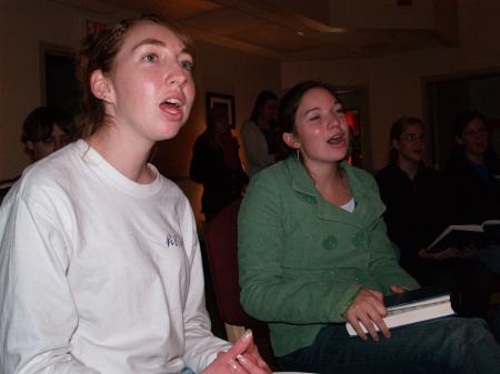 Bets Deere and Ruth Yates sing carols before President Dockery reads the Christmas story in the McAfee Commons.
