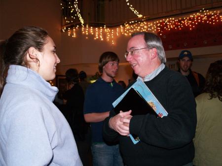 President Dockery speaks to Katie Daniel after reading the Christmas story to students in the McAfee Commons.
