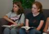 Rising Seniors Emily Watkins and Rachel Moore listen to Nick Bateman as he gives a Bible study in the McAfee commons. - Photo by Stephanie Schroeder