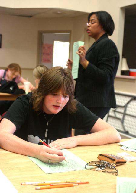 Rising Senior Tiffany Knight prepares to jot down her answers as Jacqueline Taylor, director of career services, gives instructions on a personality test. 